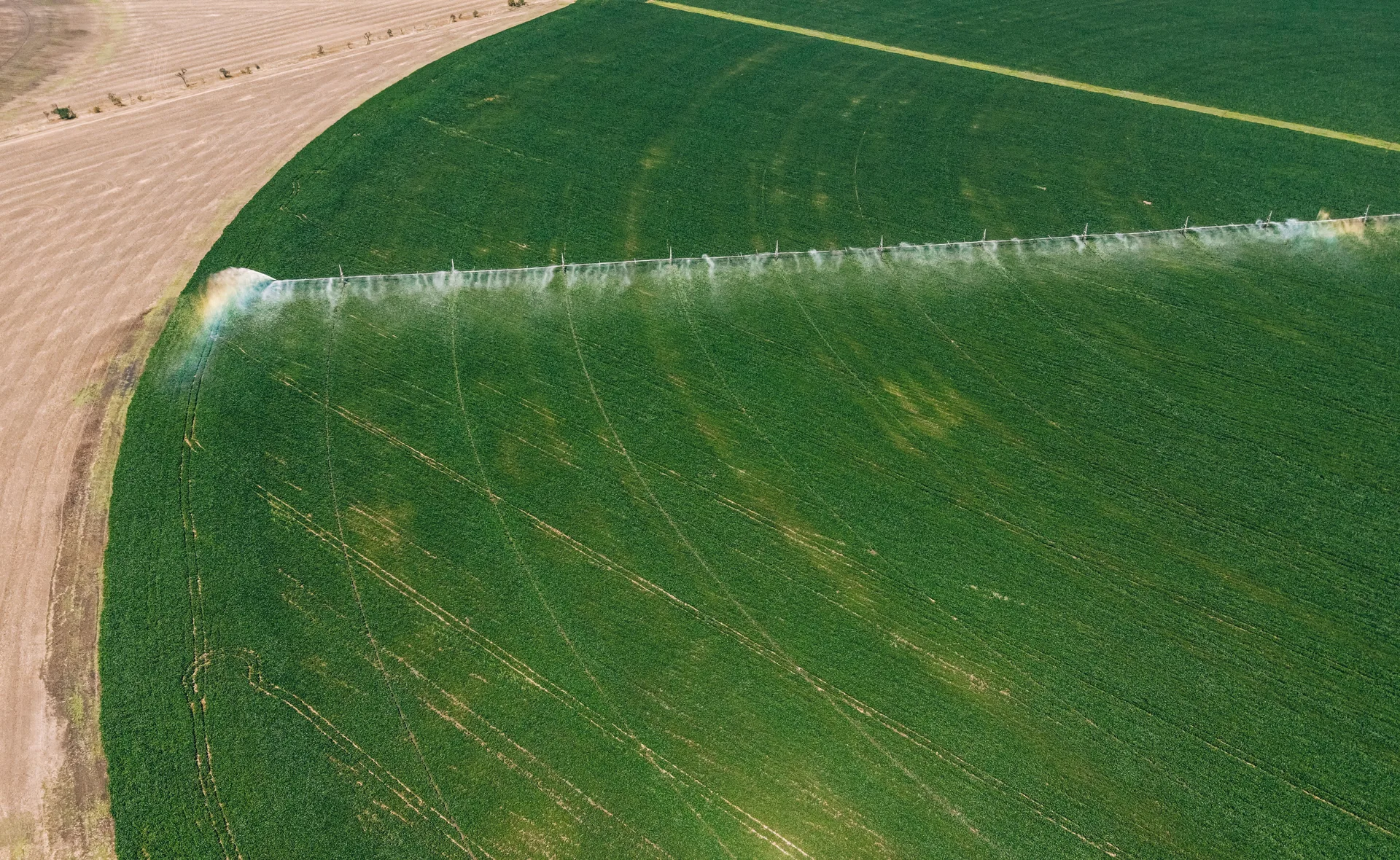 Aerial view of a DripTech centre-pivot irrigating a green field in Zimbabwe